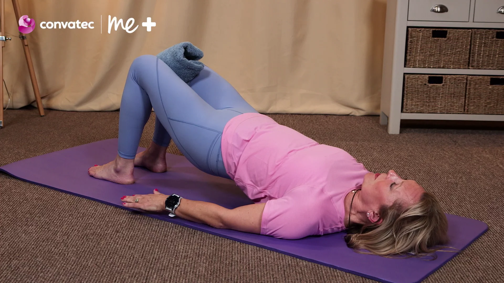 a person lying on the stomach on a purple mat